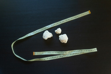 DIet concept - cauliflower wrapped with measuring tape