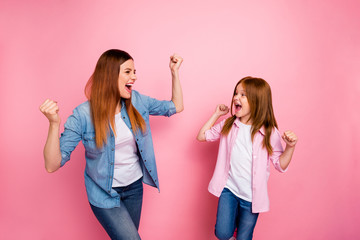 Profile side photo of cheerful people raising their fists screaming yeah wearing jeans denim shirt isolated over pink background