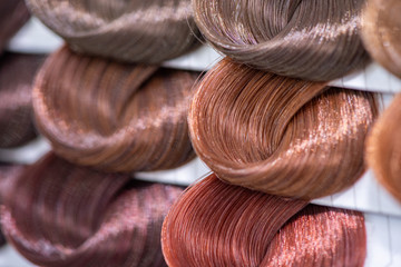 Hair color chart. Palette of dyed shiny hair samples. Catalog for selection in a beauty salon