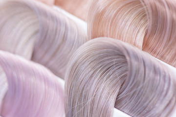 Hair color chart. Palette of dyed shiny hair samples. Catalog for selection in a beauty salon