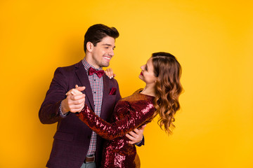 Portrait of his he her she nice-looking attractive lovely well-dressed pretty gorgeous charming fascinating cheerful cheery people having fun isolated over bright vivid shine yellow background