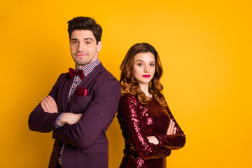 Portrait of his he her she nice attractive elegant charming smart serious content people standing back to back folded arms isolated over bright vivid shine yellow background