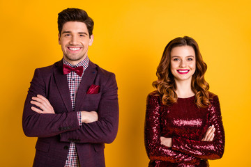 Portrait of his he her she nice attractive elegant charming lovely pretty glamorous cheerful cheery people folded arms isolated over bright vivid shine yellow background