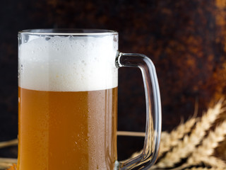 Mug of wheat beer on rusty old dark background with copy paste