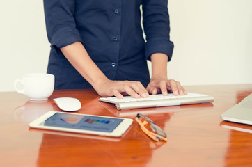 woman hands are typing on computer keyboard. Working  on desk