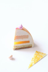 Contemporary Dome Mousse Cake with pink grapefruit, orange and cream cheese mousse, covered with velvet spray and pink mirror glaze, on white background.