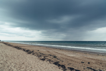 Fototapeta na wymiar Beach with dark clouds and incoming rain storm