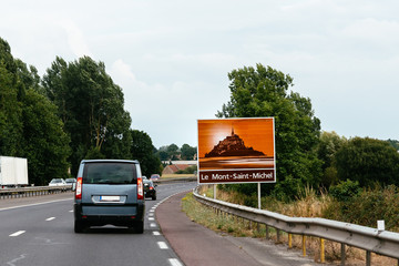 Road sign in highway announcing Mount Saint Michel © jjfarq