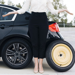 Fototapeta premium Medium shot of woman and black car