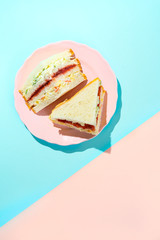 Trendy Korean sandwich inkigayo on two-color pastel background, top view, vertical orientation