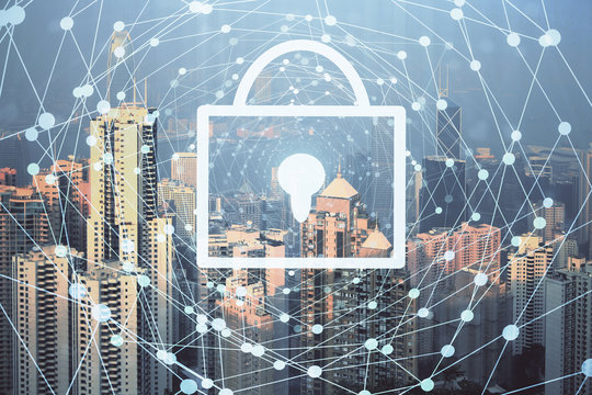 Lock icon hologram on city view with skyscrapers background multi exposure. Data security concept.