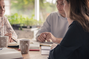 Christian worship and praise. Happy friends praying and reading the bible together.