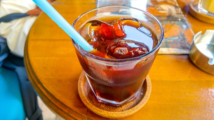 cold coffee with ice cubes and pipette in a coffee shop