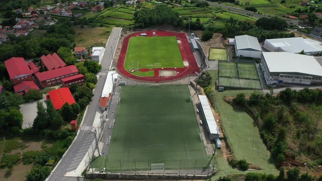 empty green rugby, football field and tennis courts, top view