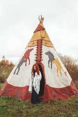 redhead modern girl near Native American TeePee Campsite