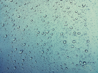 Beautiful raindrops on a window, Raindrops Or Vapor Trough on the glass, Abstract of raindrops on the mirror with a colored background. Drops of water - Image