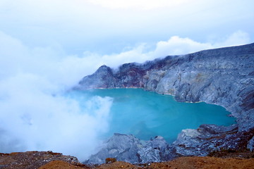 Kawah Ijen Volcano on East Java, covered in mist and clouds in the early morning;