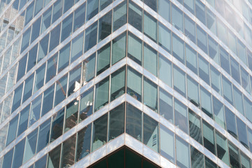 modern office building with reflection in windows of building