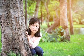 Asian child girl suffering paranoid,scared,stressed,nervous insecure and hallucinations sitting feeling afraid increasing fear anxiety,person worried confused  expression,depression,schizophrenia 