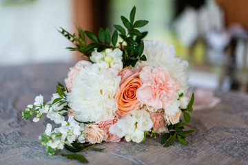 bouquet of flowers of the bride composed of peonies and roses