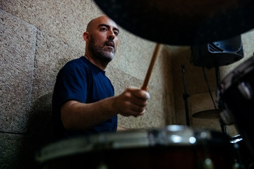 Man playing the drums of a musical group