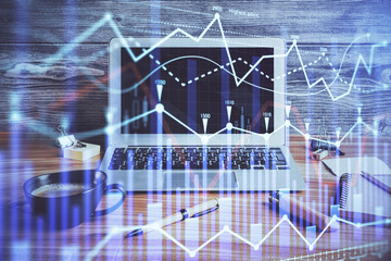 Double exposure of graph and financial info and work space with computer background. Concept of international online trading.