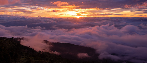 Foggy autumn landscape. Colorful fog and mountains on morning sky background. sunrise