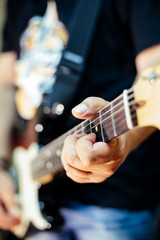 Detail of a rocker playing the electric guitar