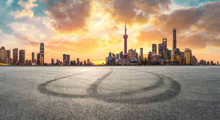 Shanghai skyline and modern buildings with empty race track at sunrise,panoramic view.