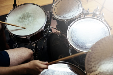 Man playing the drums of a musical group