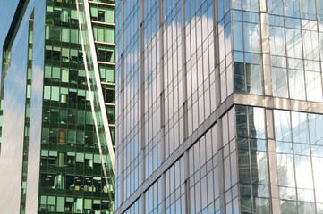 reflection of a blue sky with clouds in the glass of a skyscraper