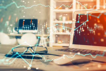 Forex market chart hologram and personal computer background. Double exposure. Concept of investment.