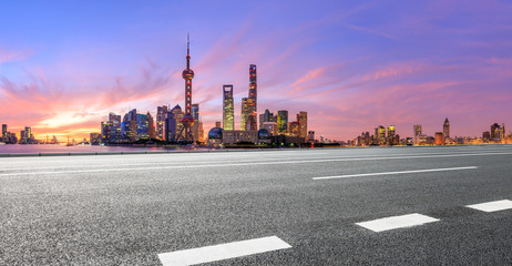 Fototapeta na wymiar Shanghai skyline and modern buildings with empty asphalt highway at sunrise,panoramic view.