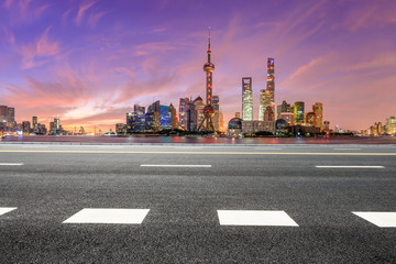 Fototapeta na wymiar Shanghai skyline and modern buildings with empty asphalt highway at sunrise,China