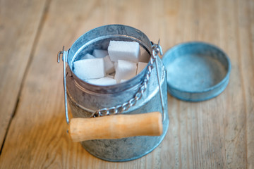 sugar in aluminum can on the wooden table