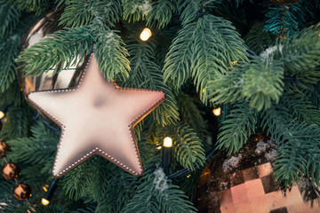 Details decorated Christmas tree with golden star balls, garland. Outdoor fair. Xmas card and...