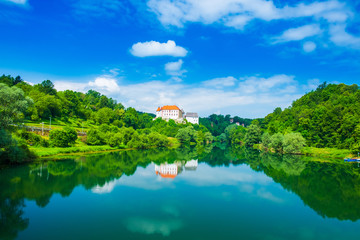 Fototapeta na wymiar River Kupa and beautiful old Ozalj Castle on the hill in town of Ozalj, Croatia