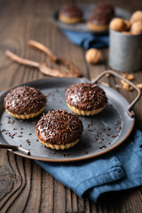 Sweet Linzer cookie cups with walnut filling, topped with chocolate