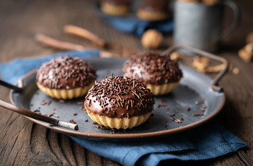 Sweet Linzer cookie cups with walnut filling, topped with chocolate