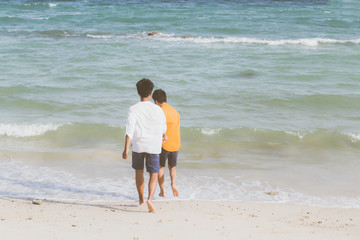 Homosexual portrait young asian couple running with cheerful together on beach in summer, asia gay going tourism for leisure and relax with happiness in vacation at sea, LGBT legal concept.