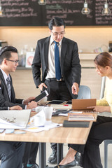 Business team discussing about new project at coffee shop.