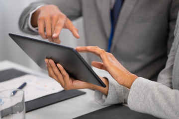 business and technology concept - hands of people with tablet pc computer at international conference