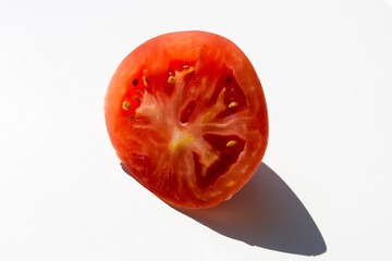 slice of tomato on fork isolated on white background