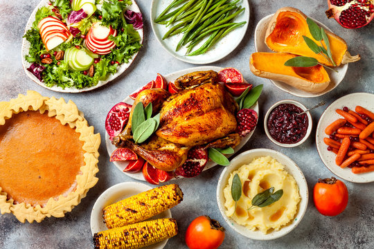 Thanksgiving Dinner Table With Roasted Whole Chicken Or Turkey, Green Beans, Mashed Potatoes, Cranberry Sauce And Grilled Autumn Vegetables. Top View, Overhead.