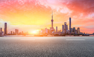 Shanghai skyline and modern buildings with empty asphalt highway at sunrise,panoramic view.