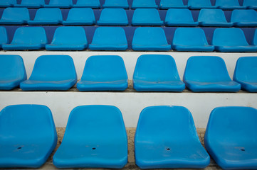 Empty plastic chairs in the stands.