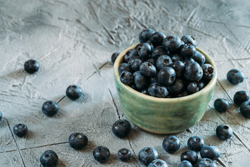 Fresh Blueberries in Plate on Table with Copy Space. Raw Organic Bilberry Close Up for Healthy Eating
