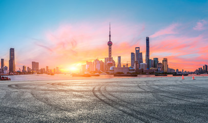 Fototapeta na wymiar Shanghai skyline and modern buildings with empty race track at sunrise,panoramic view.