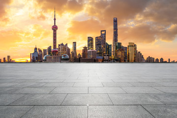 Fototapeta na wymiar Shanghai skyline and modern buildings with empty square floor at sunrise,China.