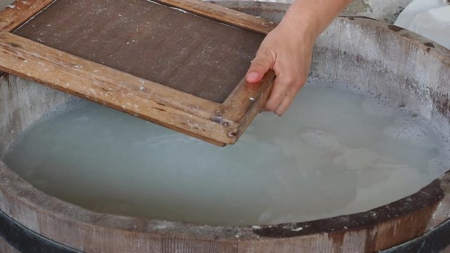 Demonstration of the medieval way to make paper from natural fibers and ash